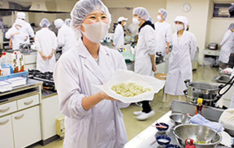 厨房で白衣を着た人たちの写真